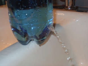 Pinching the water streams together will cause them to join into a single stream