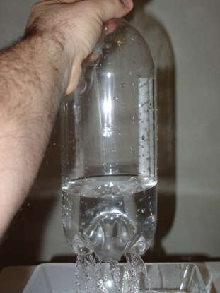 With the cap unscrewed, air isn’t trapped in the bottle. Air flows in, water flows out.