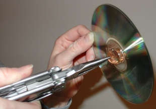 To create a CD spinner, push a hot penny through a CD’s center hole.
