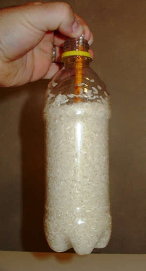 Friction keeps the pencil from sliding away from the grains of rice.