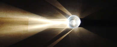 With the flashlight lined up properly, light passes straight through the glass. No refraction.