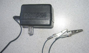 A “wall-wart” adapter connected to alligator clips